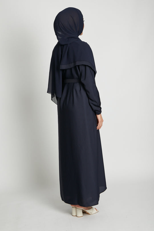 Back side full view of open kimono abaya in deep navy paired with white inner slip dress, elegant modest wear abaya
