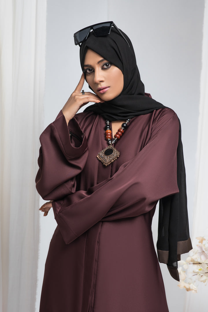 Detailed zoom-in of front fabric and stitching design on maroon jilbab simple abaya, elegant modest fashion