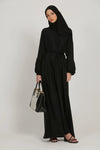 Front view of black abaya dress with simple elasticated cuffs, modest full-length design