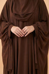 Brown abaya with a plain background