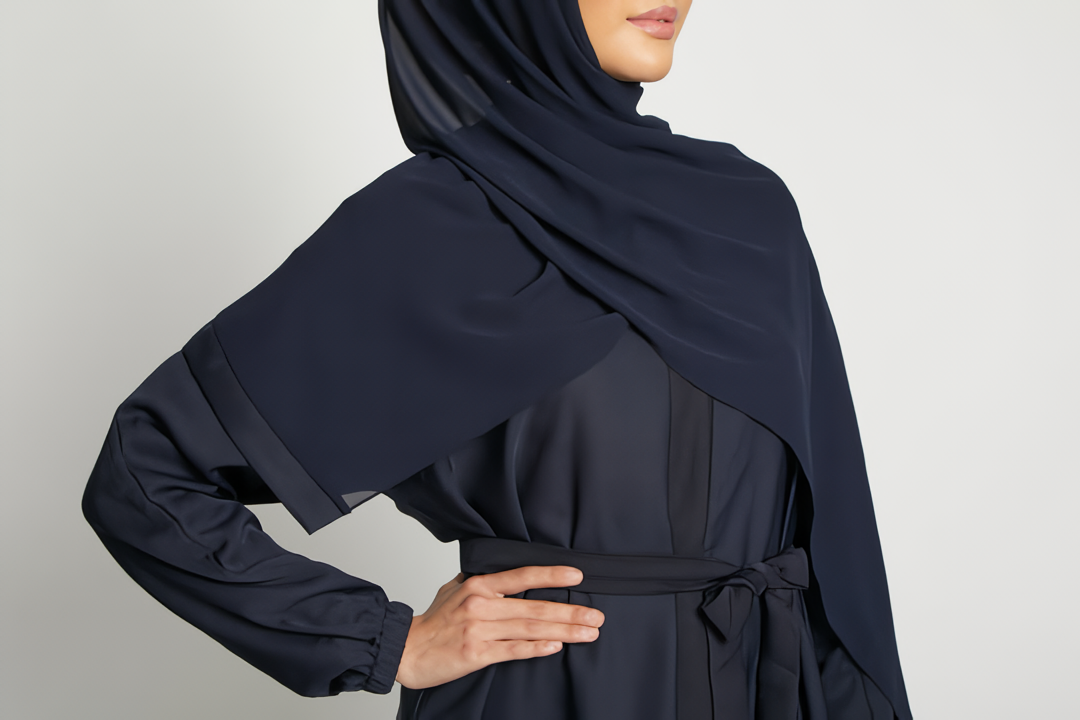 Close-up zoom of chest area on deep navy kimono abaya with white inner slip, stylish modest abaya fashion for women