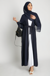 Full front view of deep navy open kimono abaya with white inner slip dress and elasticated cuffs, elegant modest abaya for women