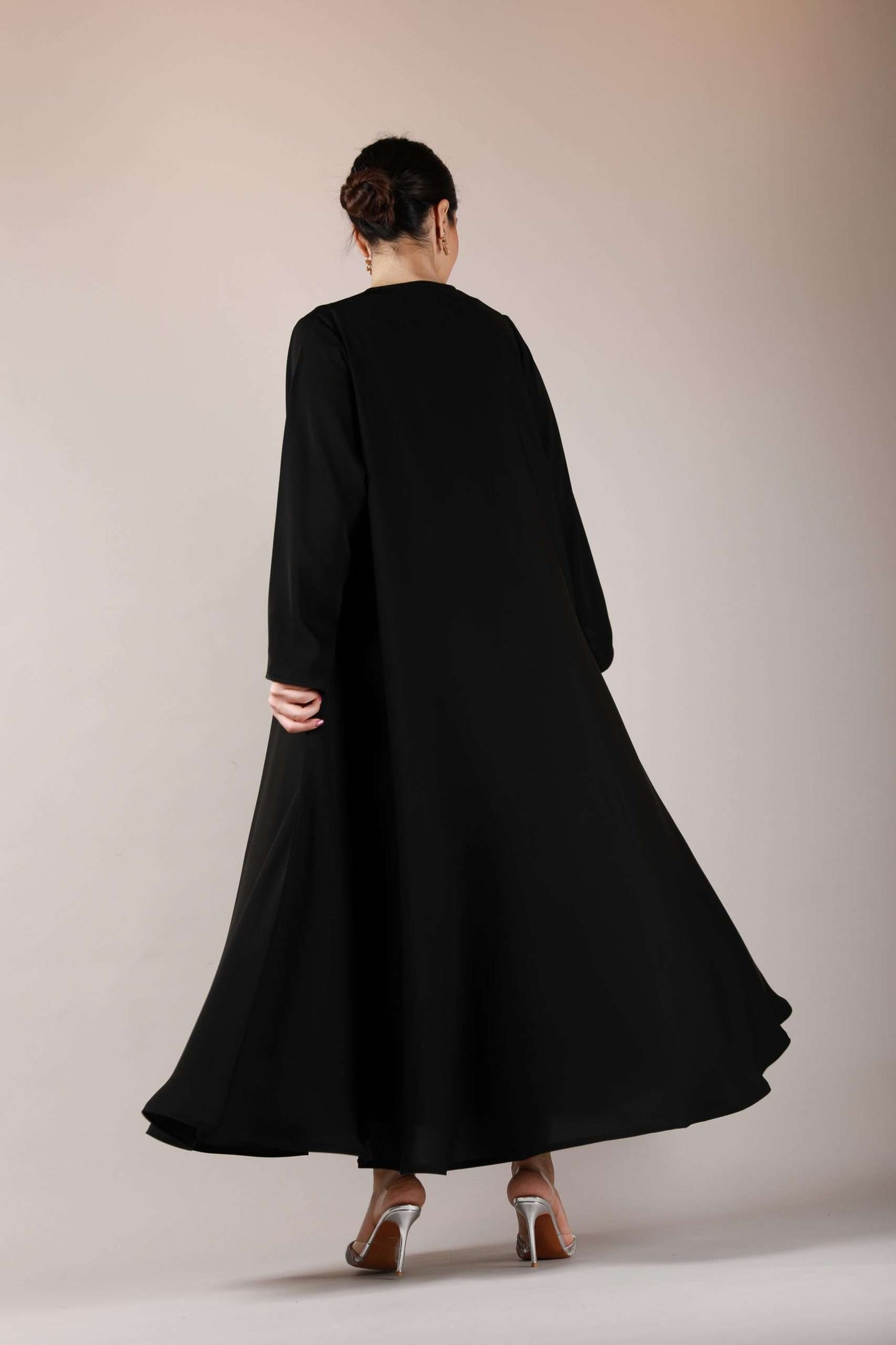 Full back view of premium nida fabric abaya highlighting the elegant wide flare and modest cut.
