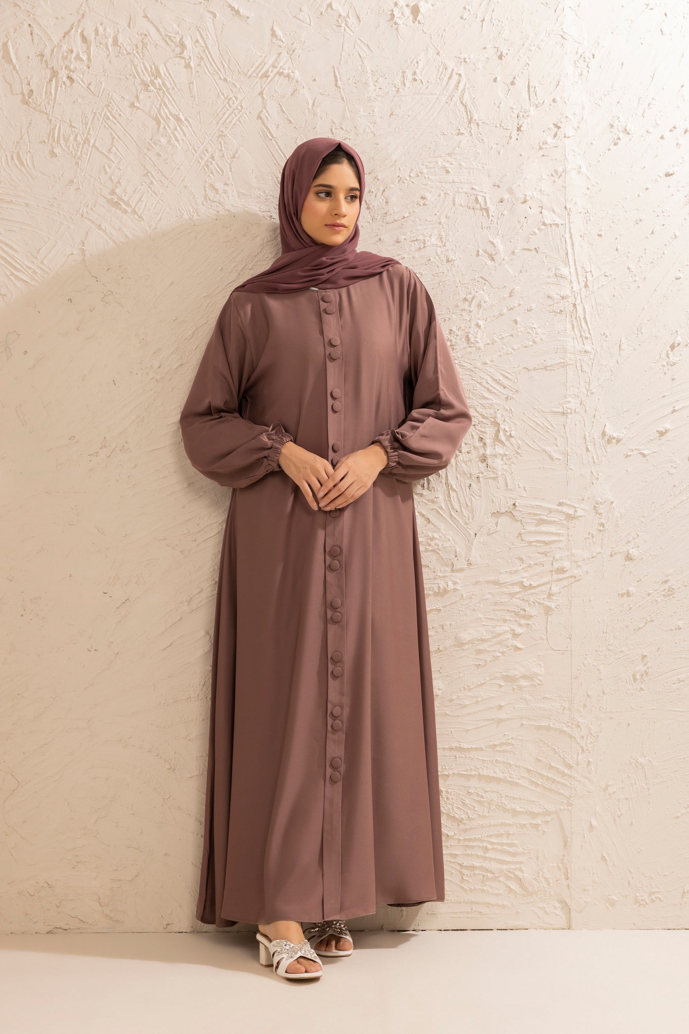 Front view of modest rose taupe abaya designed with double buttons and elasticated cuff sleeves, premium abaya for women