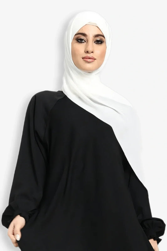 Zoom-in view of fabric and bottom flair (gair) design on plain black umbrella abaya, stylish modest abaya for women