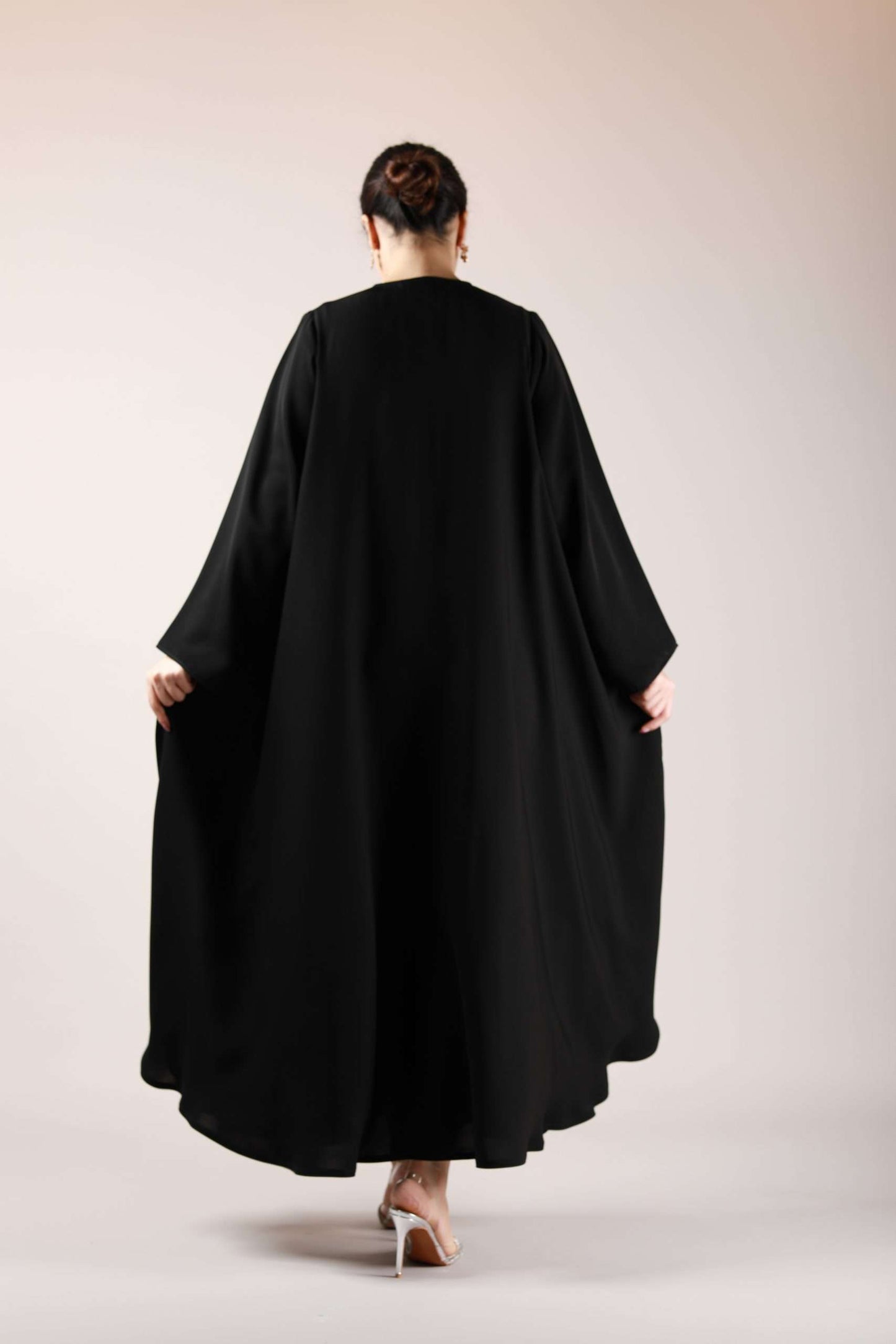 Stylish backside angle of flowy Arabic abaya in premium nida fabric, designed for modesty and elegance.