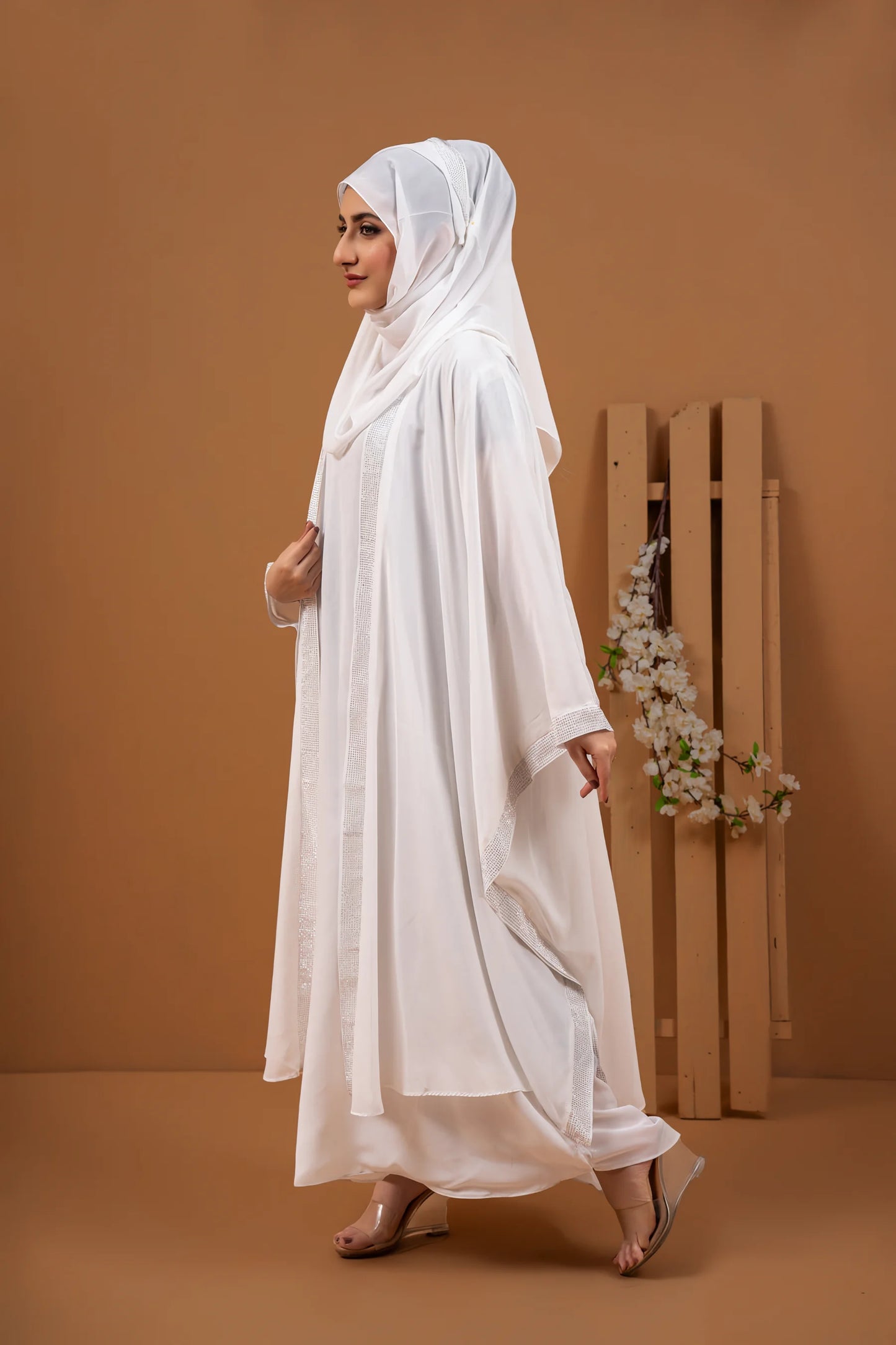 Side pose of Haleema White Kaftan Abaya displaying elegant drape and flowy design.