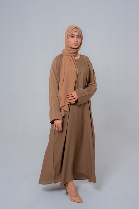 Model wearing The Basic Simple Beige Abaya highlighting premium fabric, elegant fit, and modest full-length design for women