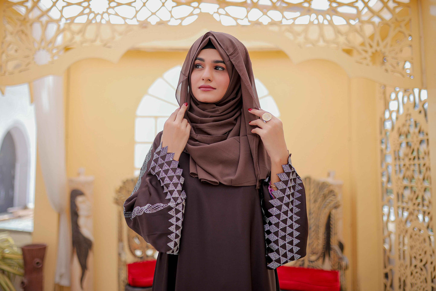 Zoomed-in front shot highlighting fabric texture and nug sleeve design of white abaya