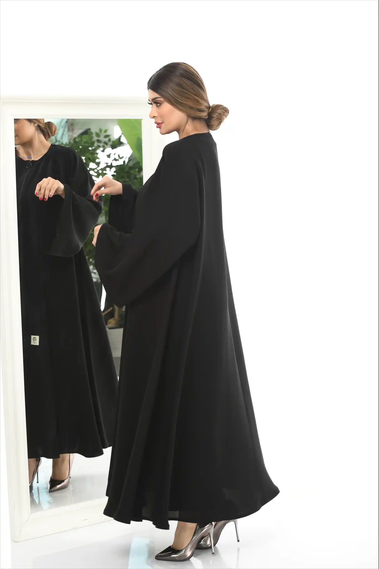 Side angle of Arabic style full zipper abaya in premium nida fabric highlighting flow and tailored cut.