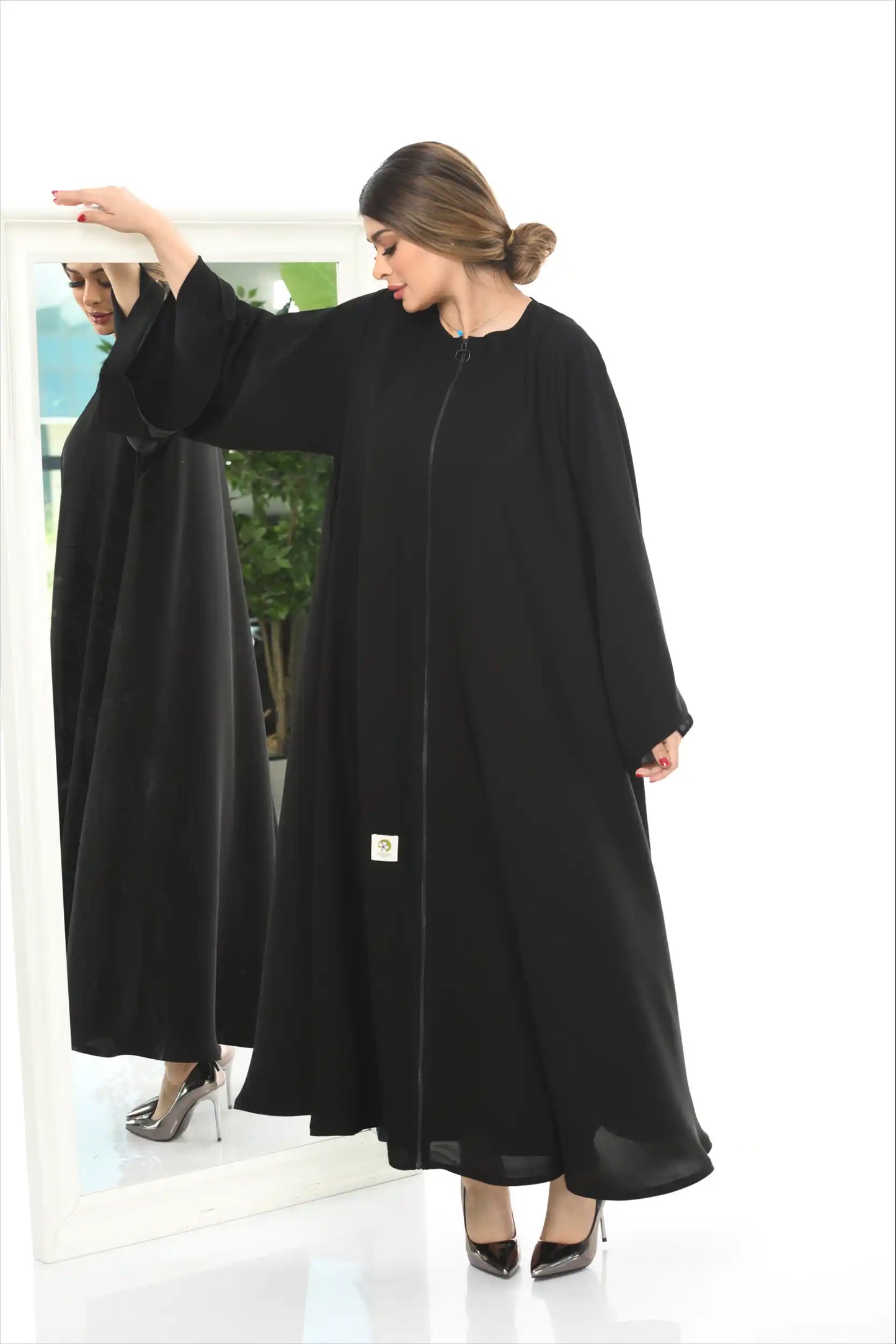 Side detail of full zipper abaya in premium nida fabric emphasizing silhouette and comfortable modest styling.