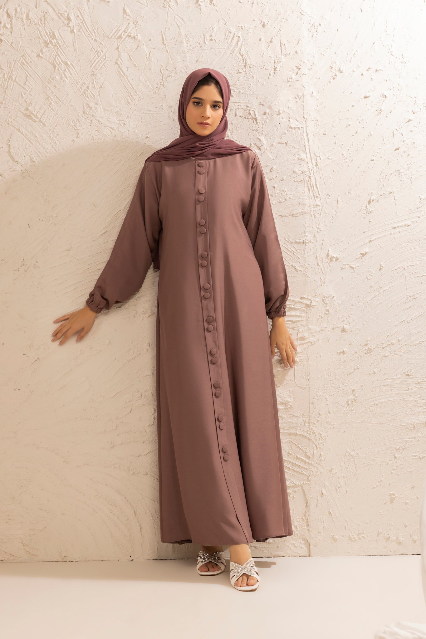 Front view of rose taupe abaya featuring double button closure and long cuff sleeves, modest Islamic dress for women
