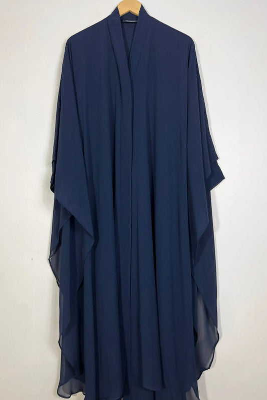 Halimah blue front open butterfly abaya hanging on hanger showing double layer chiffon fabric and flowing cut