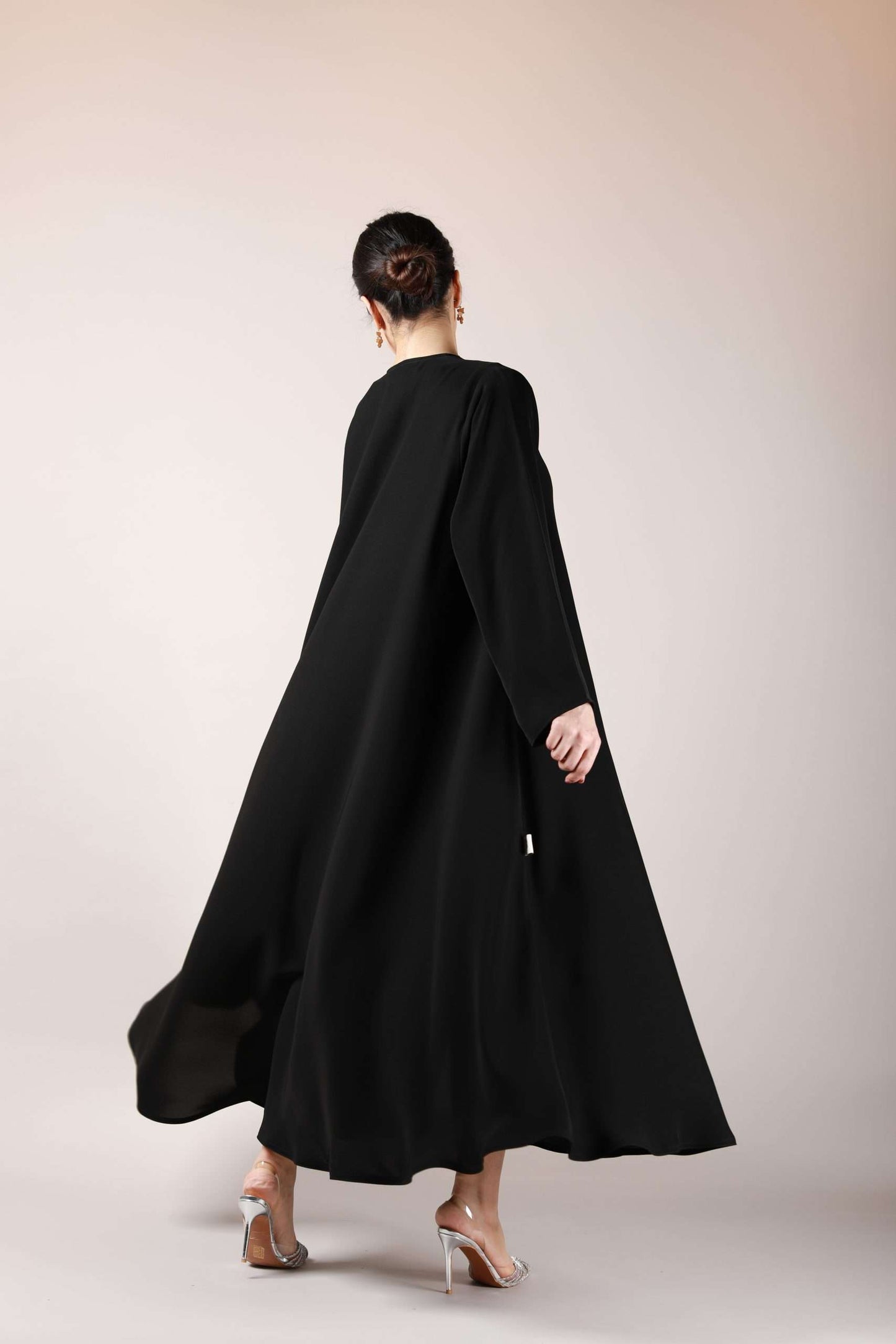 Backside view of front open Arabic abaya showcasing its wide bottom gair and flowing nida fabric.