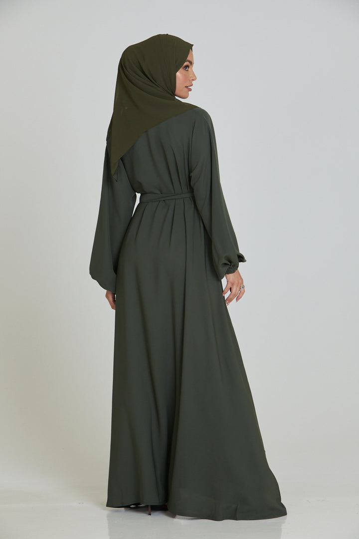 Back side full view of plain umbrella abaya in olive color with simple belt, modest abaya for women in Pakistan