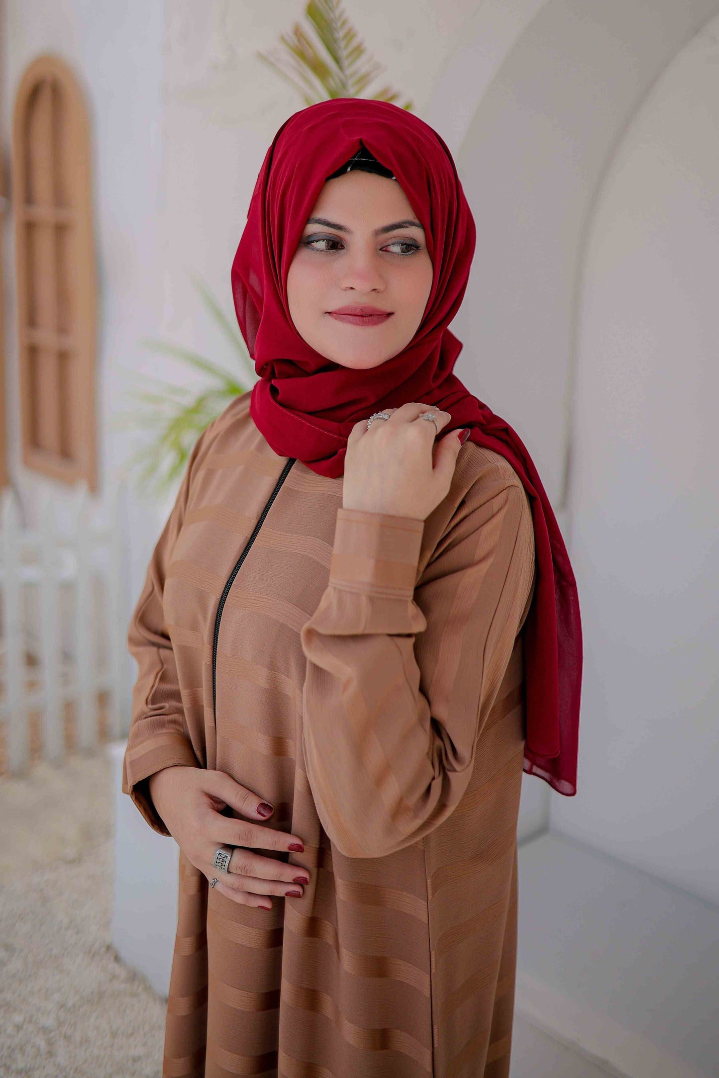 Zoomed-in view of beige abaya fabric and zipper detailing