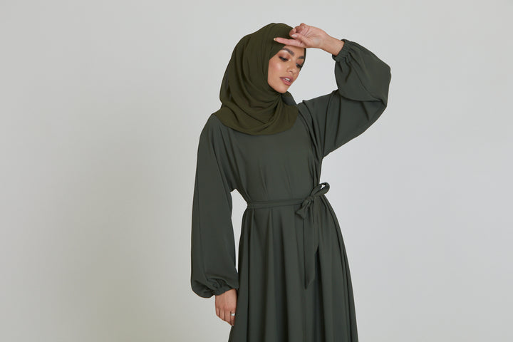 Zoom-in detail of belt design on premium plain olive umbrella abaya with elastic cuffs, stylish modest abaya dress