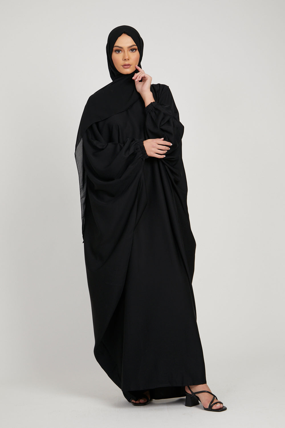 Full front view of black abaya kaftan dress, modern modest abaya for women with elasticated sleeves in Pakistan
