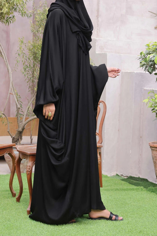 Side pose of black kaftan abaya with flowing silhouette and modest fit, styled with matching dupatta.