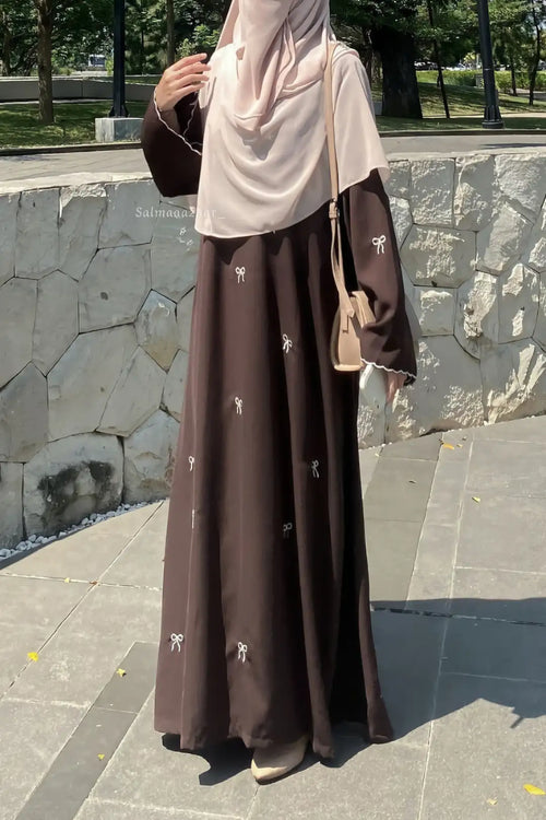 Modest Bow Embroidered Zoom Nida Abaya front view featuring intricate bow embroidery and a graceful flowing silhouette.