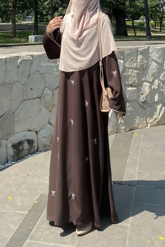 Modest Bow Embroidered Zoom Nida Abaya front view featuring intricate bow embroidery and a graceful flowing silhouette.