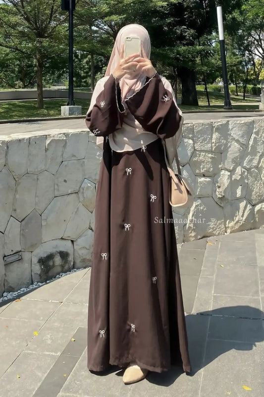 Elegant Bow Embroidered Zoom Nida Abaya in black shown from the front, featuring a modest silhouette and delicate bow embroidery.