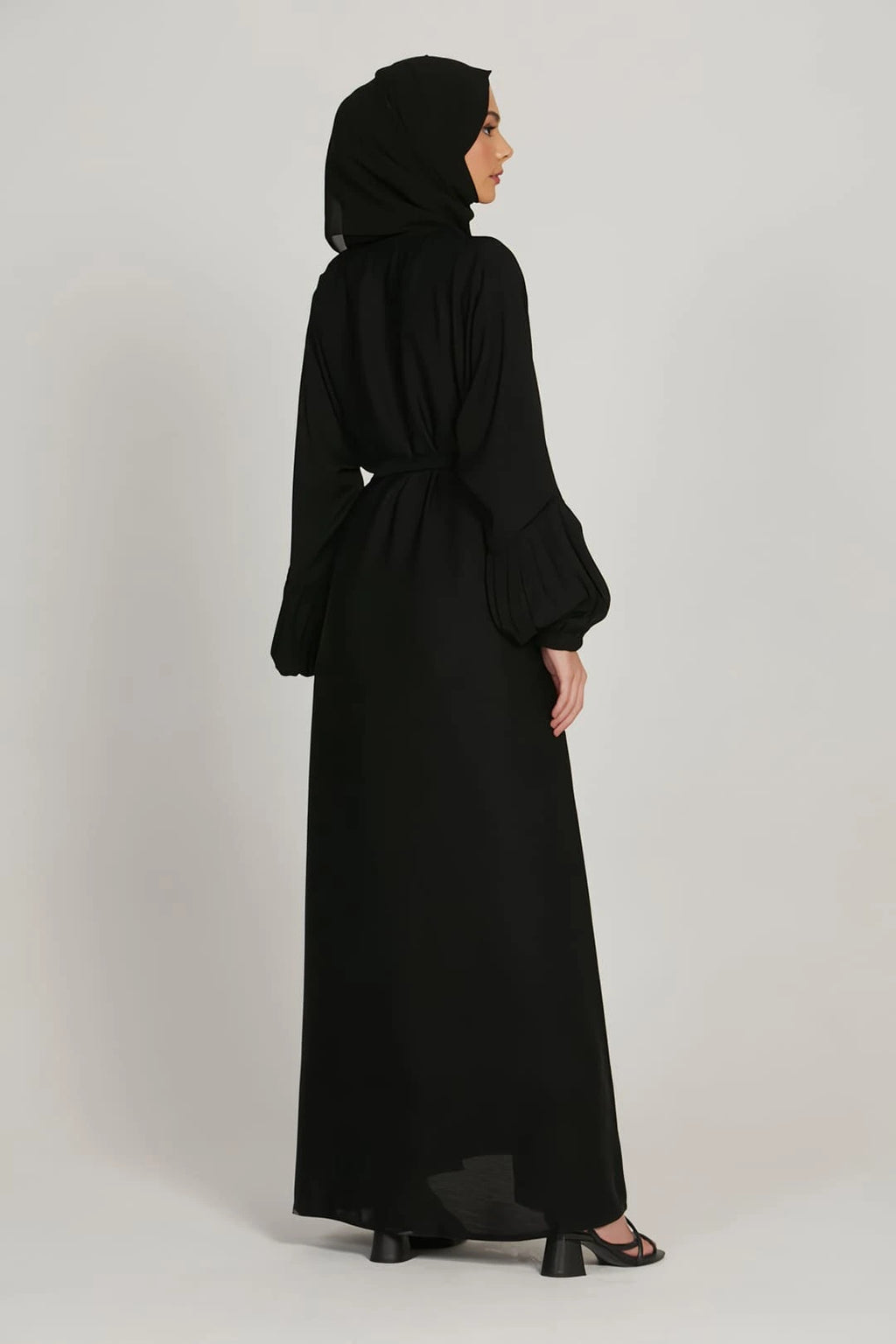 Back view of black abaya dress showing loose fit and simple elasticated cuffs