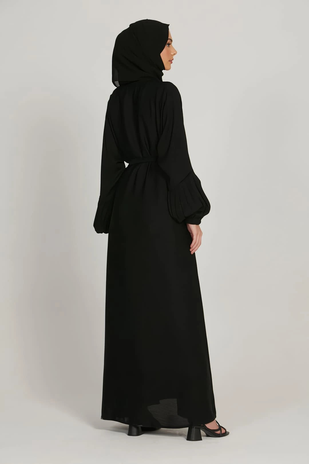 Back view of black abaya dress showing loose fit and simple elasticated cuffs