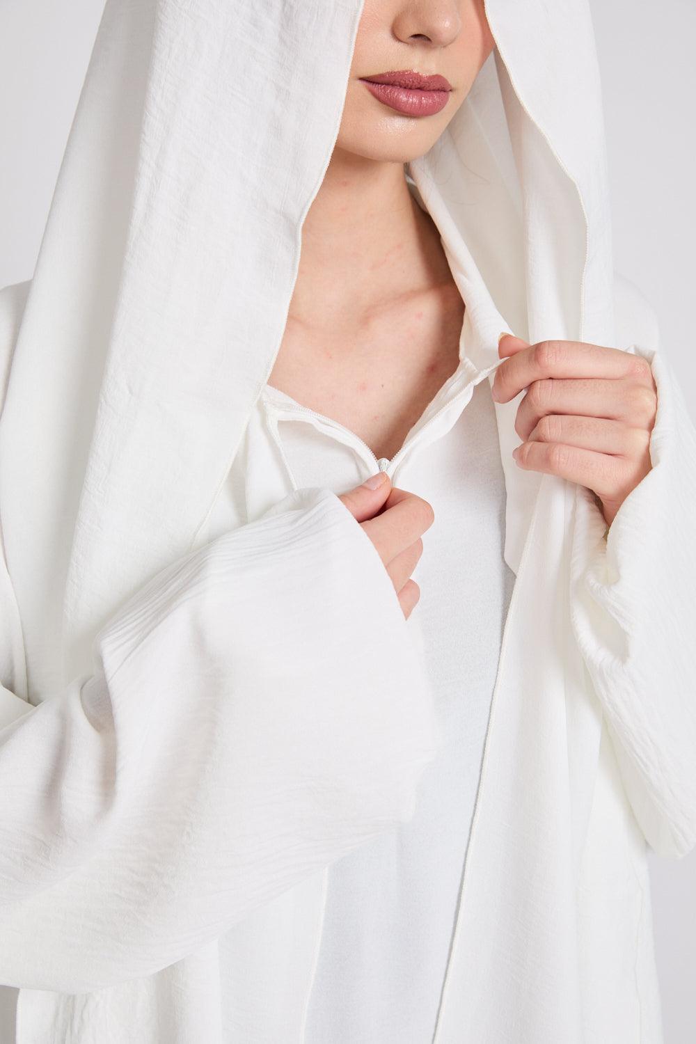 Zoom-in of White Closed Abaya front showing zip closure, neckline detail, and premium nida fabric texture