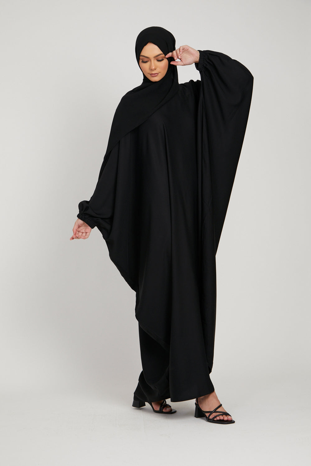 Full front view of elegant black kaftan abaya, modest clothing for women with elasticated cuff sleeves