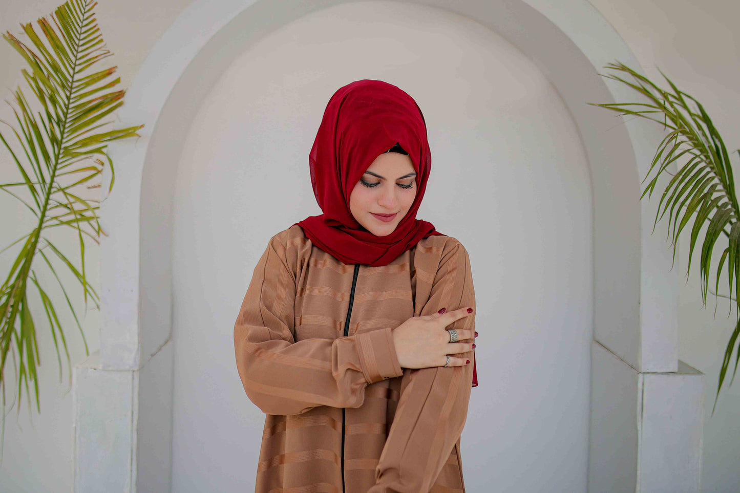Close-up shot highlighting zipper style and texture of beige abaya
