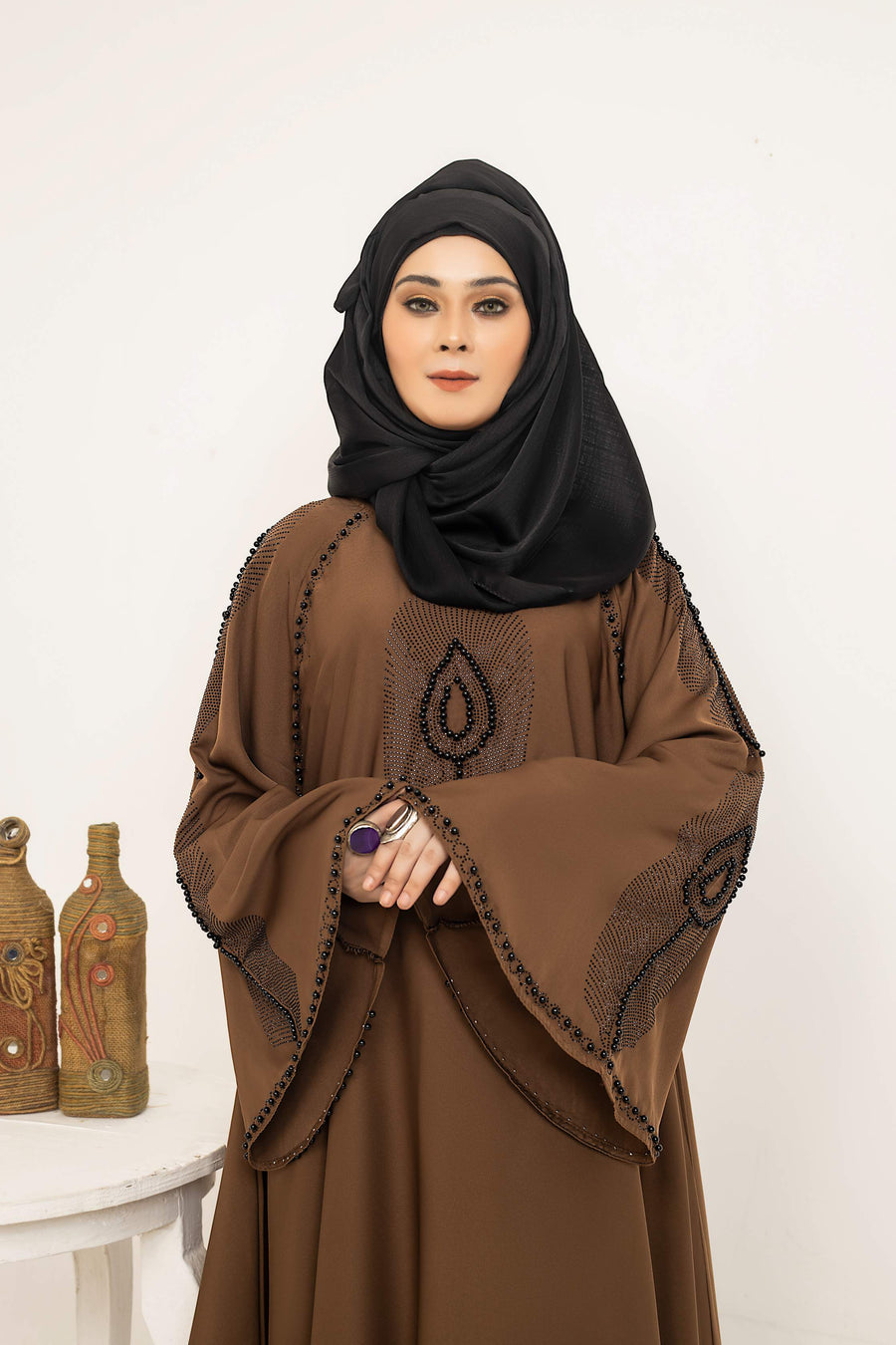 Close-up of nug and moti embellishment design on abaya front, stylish modest wear abaya for women in Pakistan