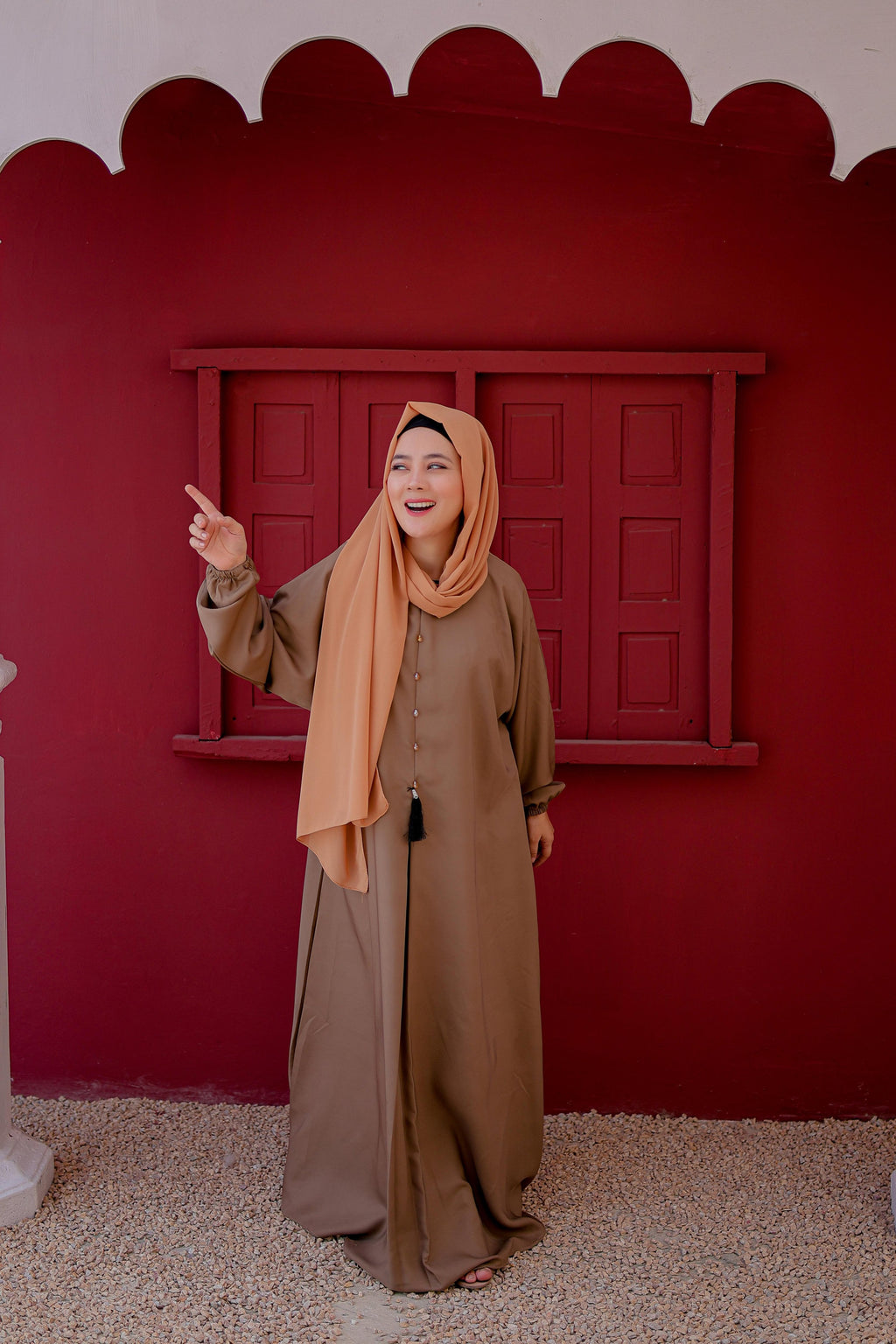 Front view of light brown plain abaya featuring elastic cuffs for comfort and style