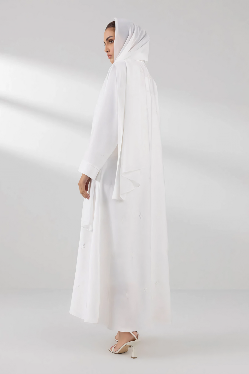 Side view of plain white front open abaya showcasing modest and stylish wear for women