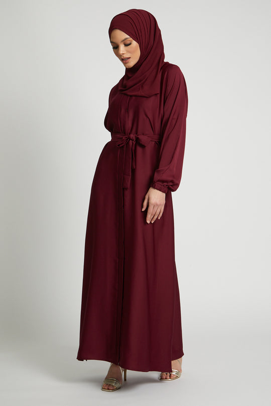 Side view of long red kimono abaya with waist belt and elastic cuffs, modest women’s abaya dress