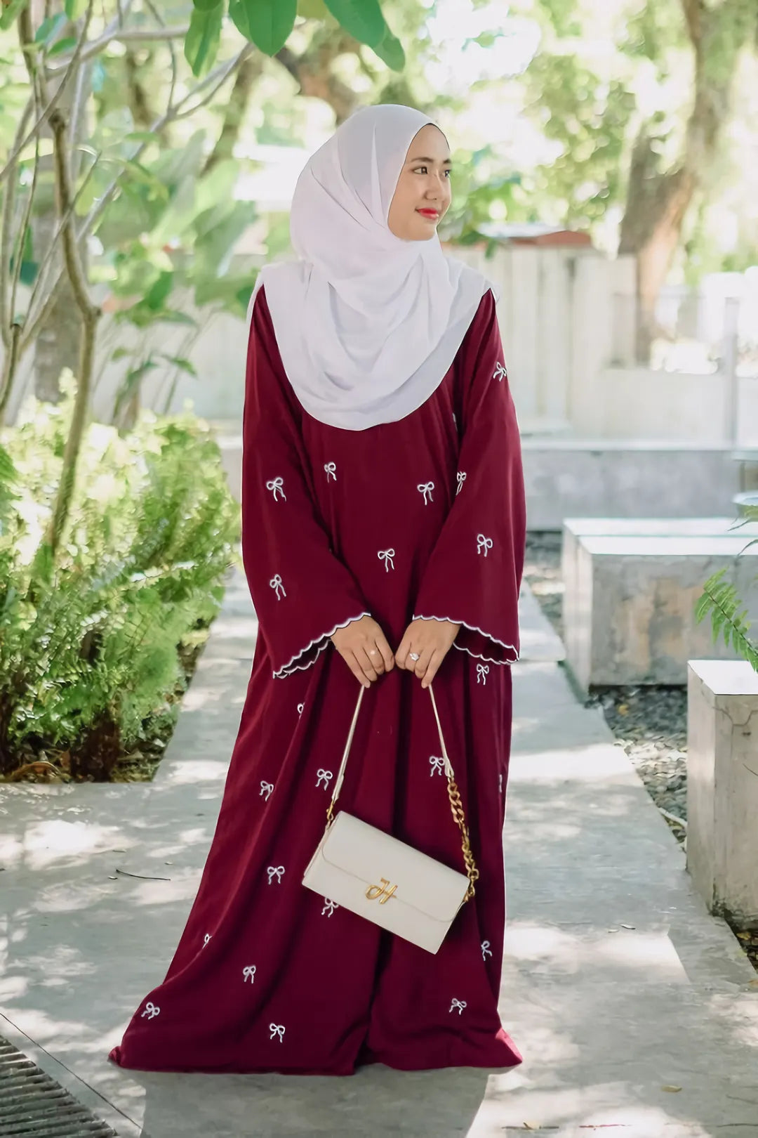 Full front pose of Red Bow Embroidered Zoom Nida Abaya in red, highlighting intricate embroidery and flowing design.