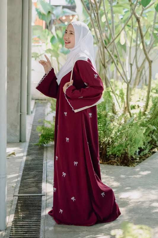 Side view of Red Bow Embroidered Zoom Nida Abaya, showing graceful fall of Zoom Nida fabric and bow embroidery details.