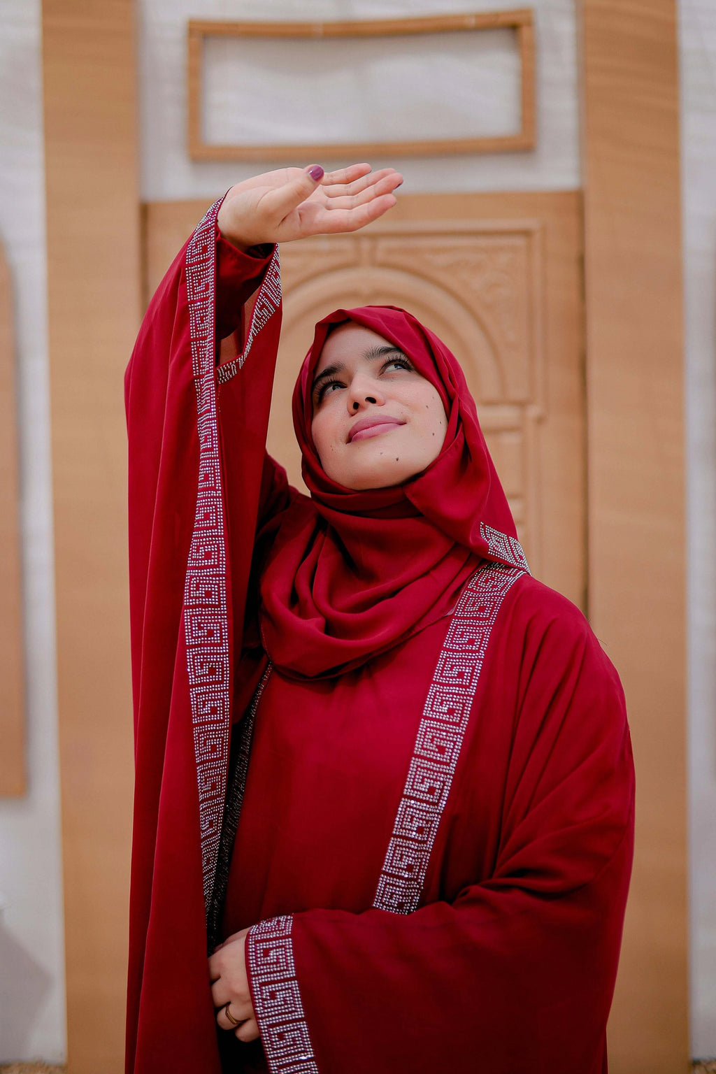 Side angle of red kaftan abaya in Arabic style with modest and flowy silhouette