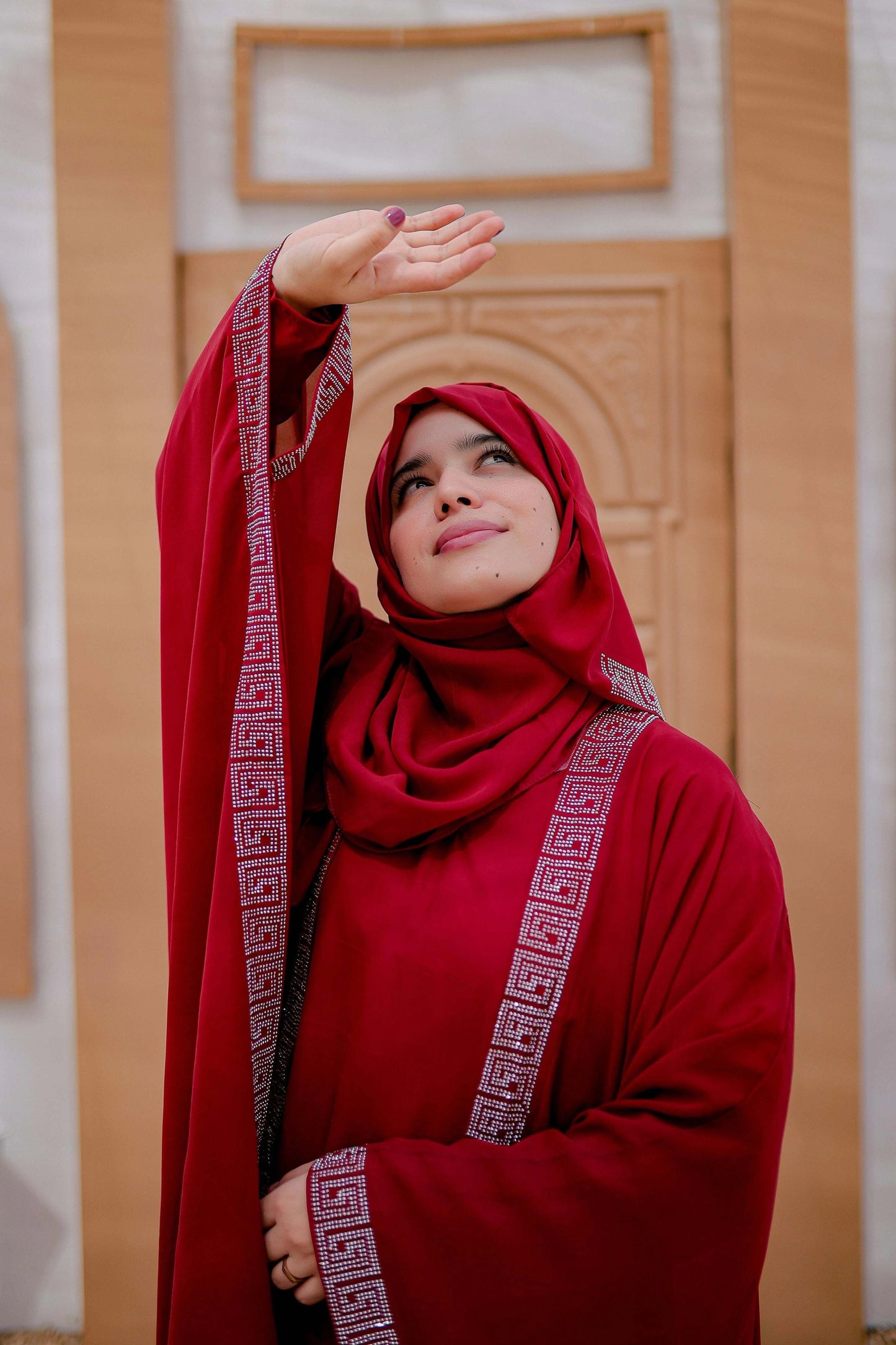 Side angle of red kaftan abaya in Arabic style with modest and flowy silhouette