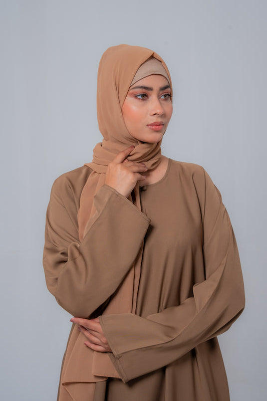 Side angle of The Basic Simple Beige Abaya highlighting flowy silhouette and comfortable modest styling for women