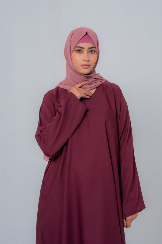 Zoom-in close-up of The Basic Simple Maroon Abaya front highlighting premium nida fabric texture, stitching details, and elegant modest design for women