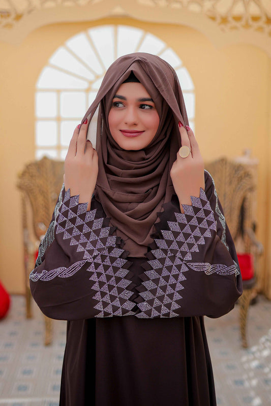 Close-up front view showing nug work embroidery on sleeves of plain white abaya