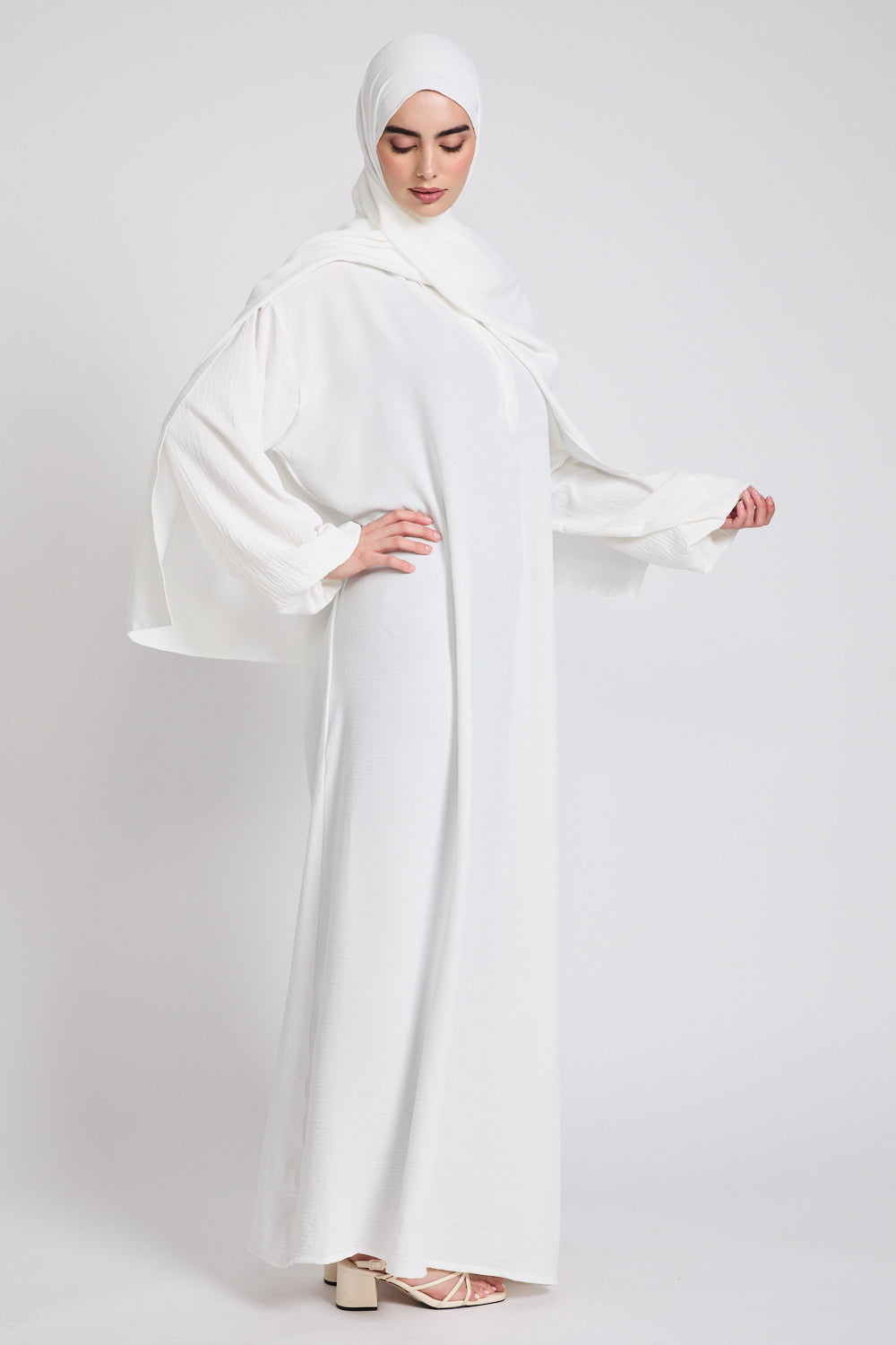 Side angle of White Closed Abaya with Front Zip showing flowy silhouette, comfortable modest style, and elegant fit for women