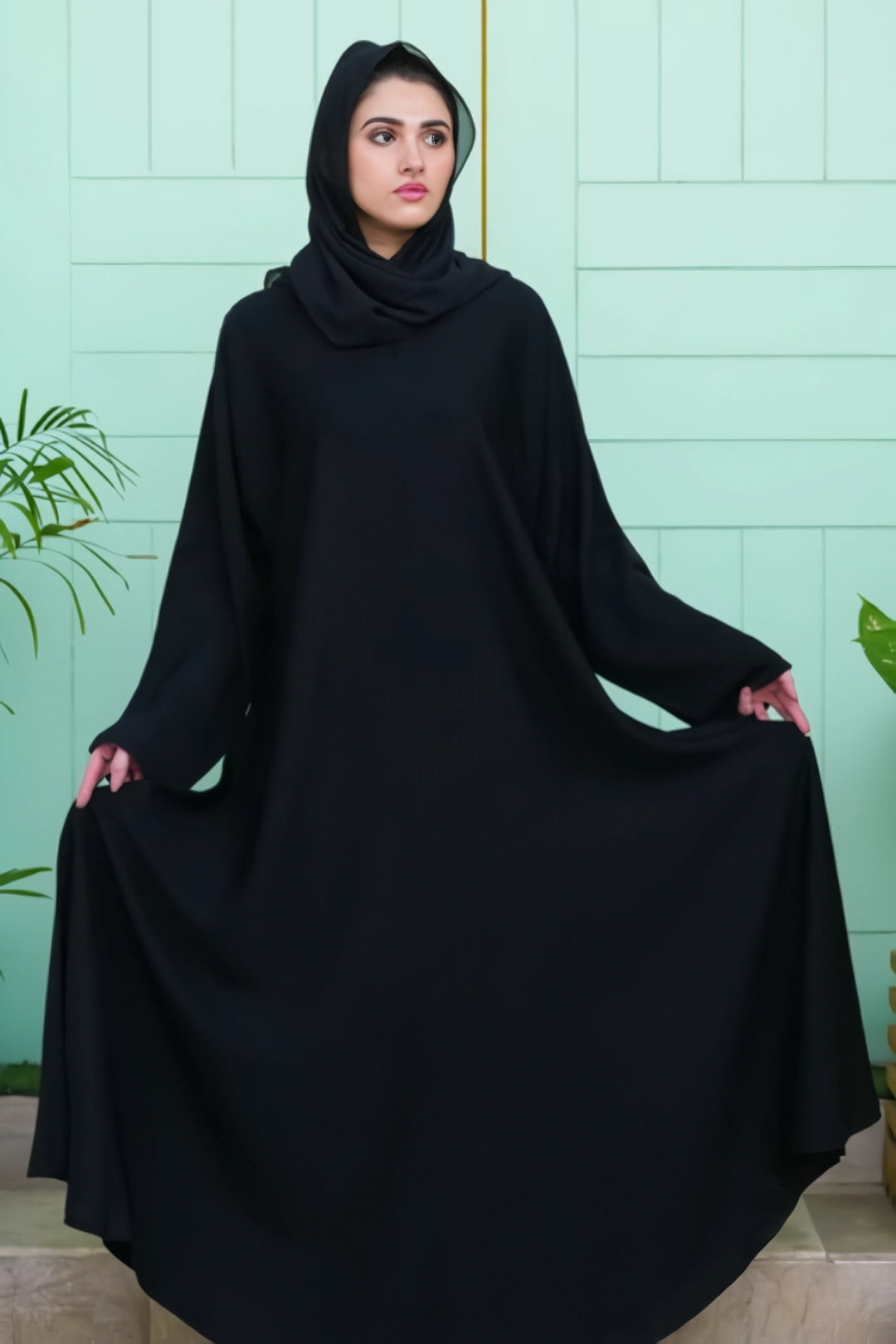 Elegant front close-up of the Plain Black Abaya highlighting its minimalist stitching and fine Nida texture.