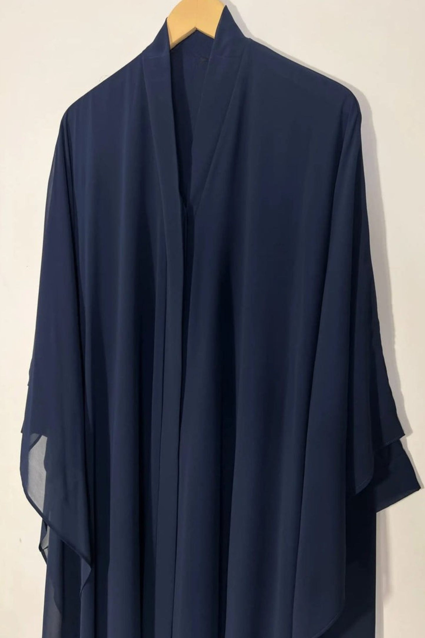 Front view of blue Halimah butterfly abaya on hanger highlighting lightweight chiffon and elegant fall
