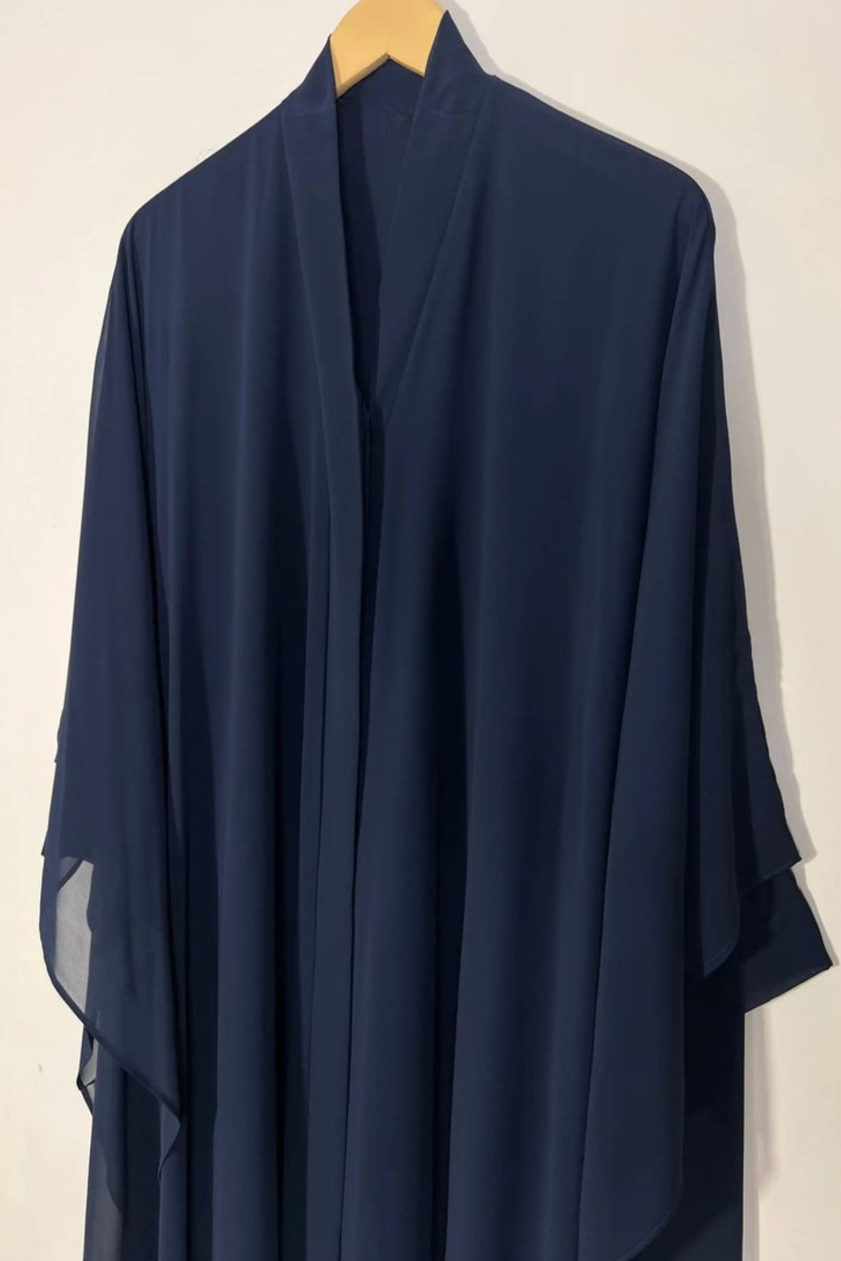 Front view of blue Halimah butterfly abaya on hanger highlighting lightweight chiffon and elegant fall