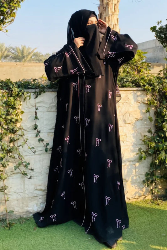 Elegant Bow Abaya front full view – premium Nida fabric abaya in black with delicate pink bow embroidery for modest women.