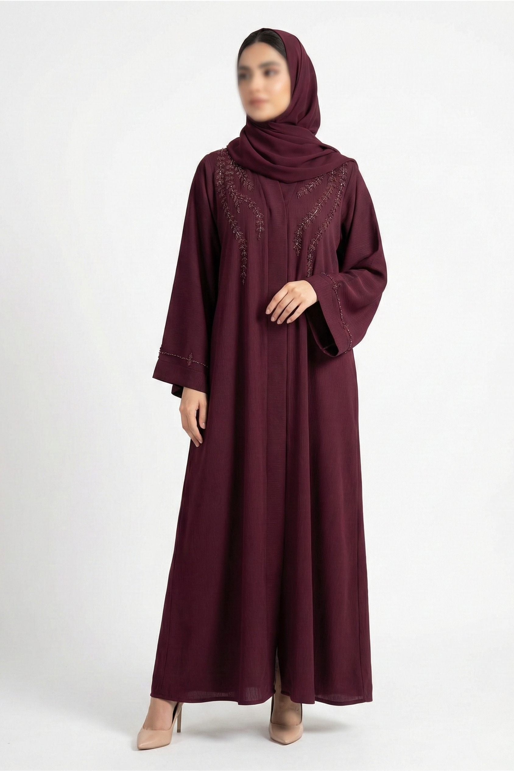 Essence of Dreams handcrafted abaya for women in deep maroon color front full view worn by model showing premium nida fabric