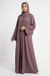 Essence of Dreams handworked abaya for women in soft pink color front full view worn by model showing premium nida fabric
