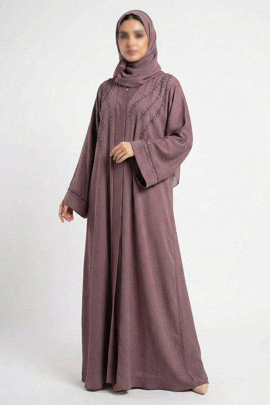 Essence of Dreams handworked abaya for women in soft pink color front full view worn by model showing premium nida fabric